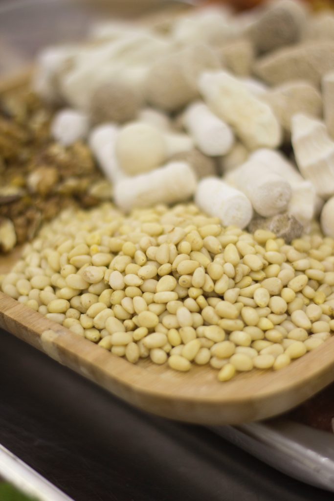 white and brown beans on brown wooden tray