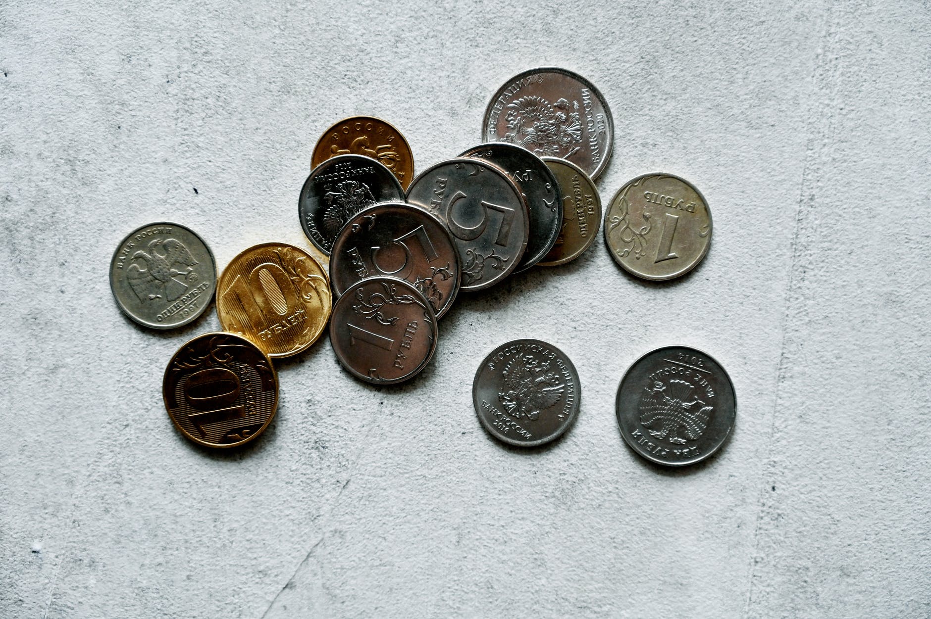 close up photo of round coins on a white surface