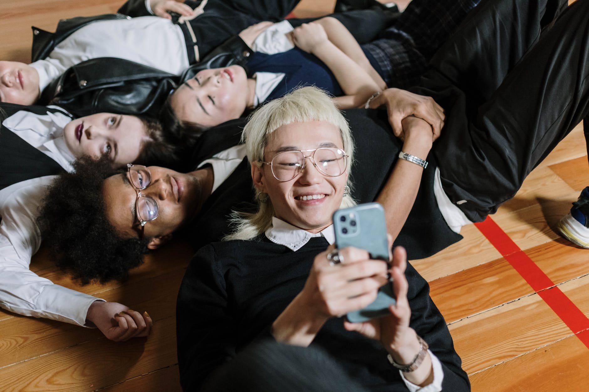 woman in black shirt holding iphone