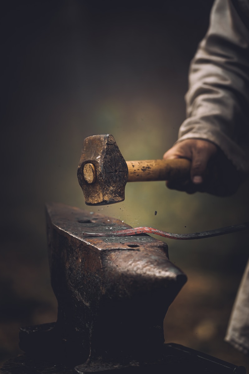 person holding gray metal tool