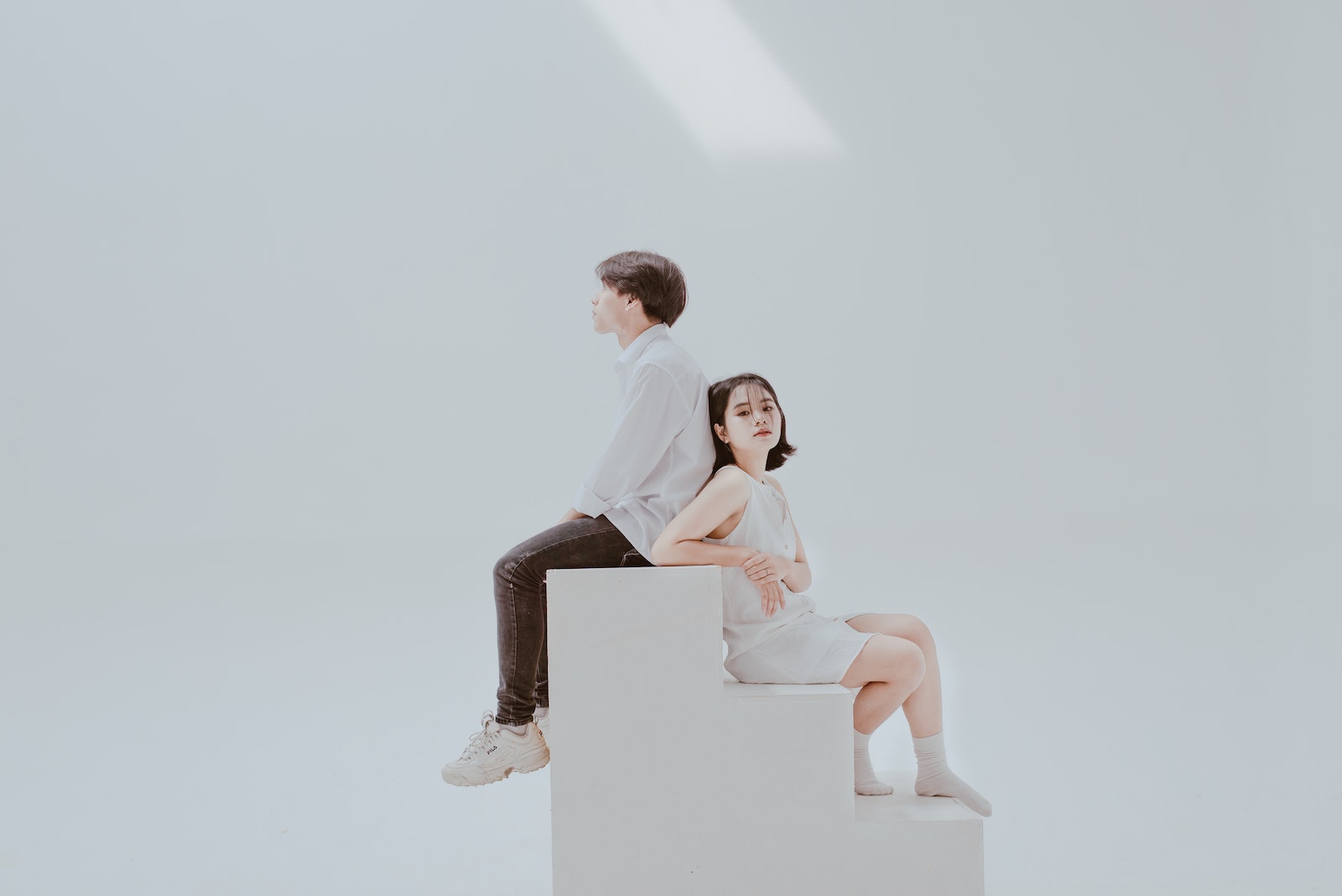 Photo of Woman Sitting on Staircase Beside Man