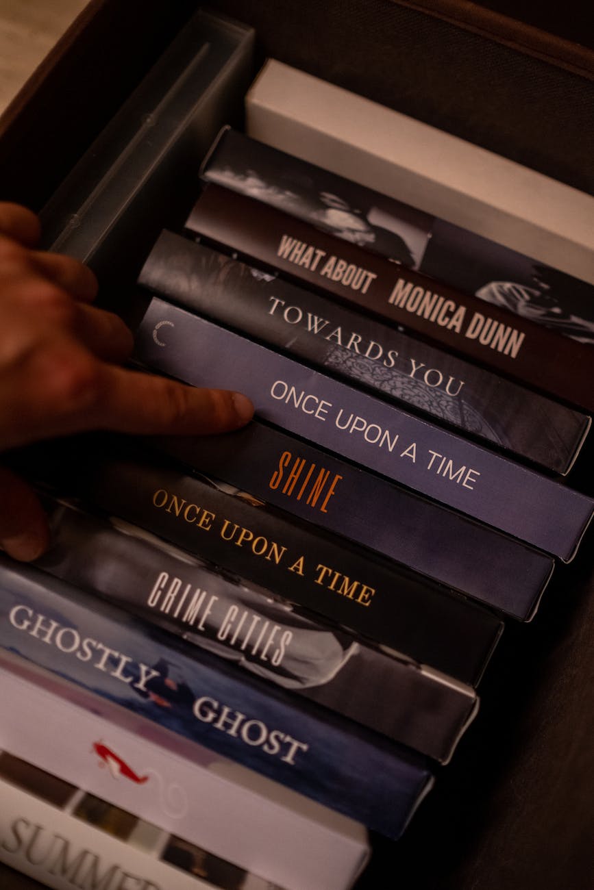 person choosing a videotape from different titles