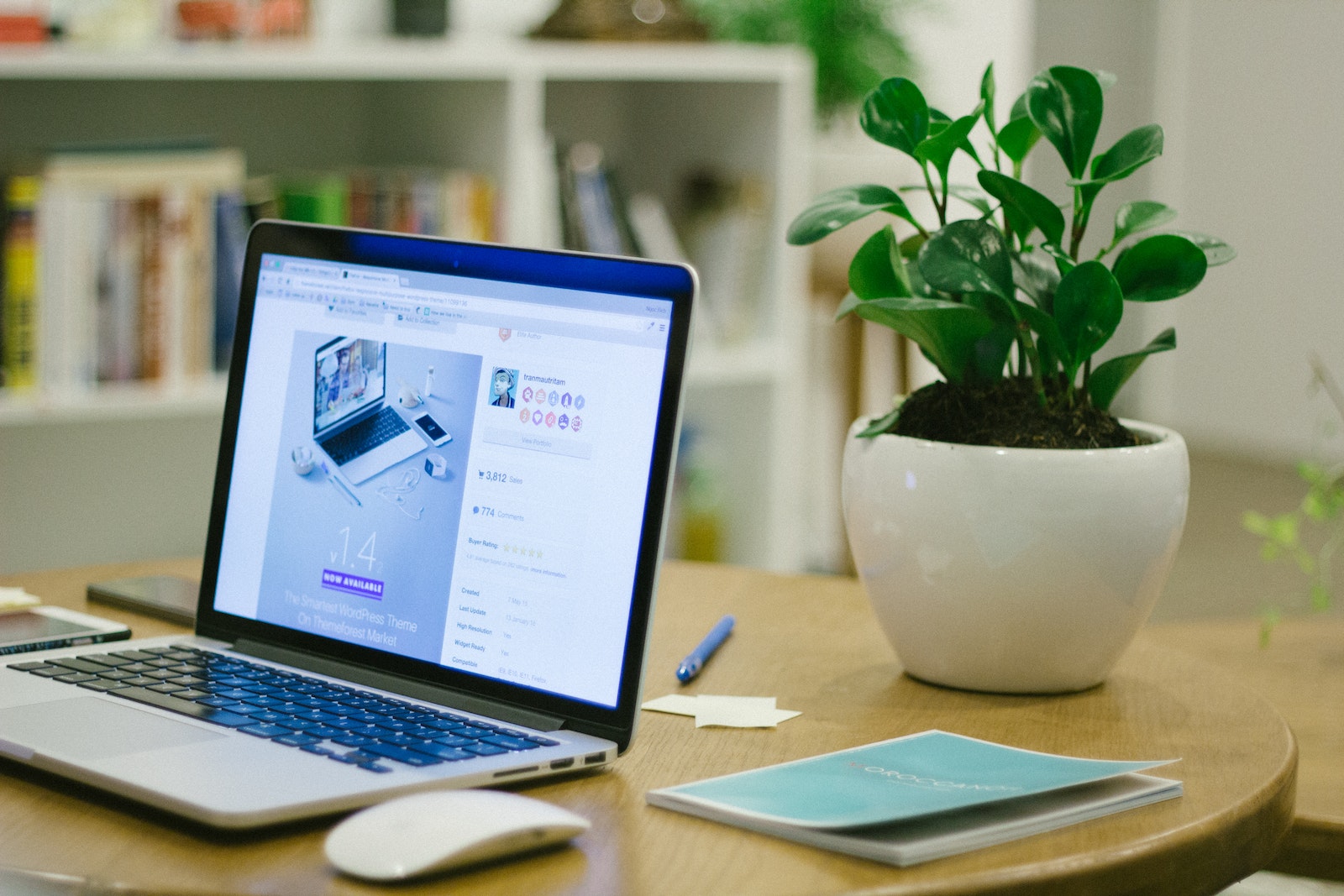 Selective Focus Photography of Macbook Pro With Turned-on Screen on Brown Wooden Table
