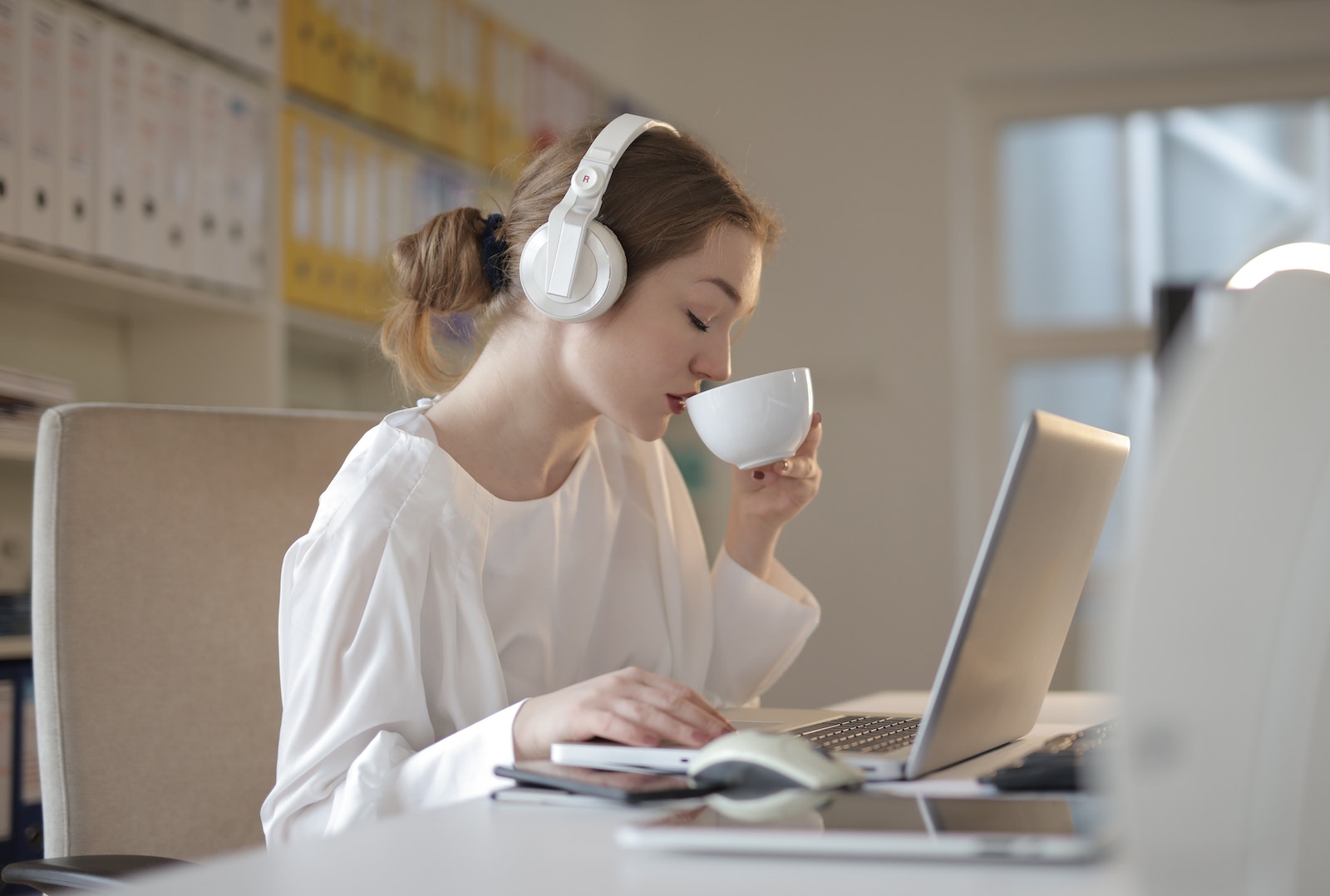 Woman in White Dress Shirt Using White Laptop Computer