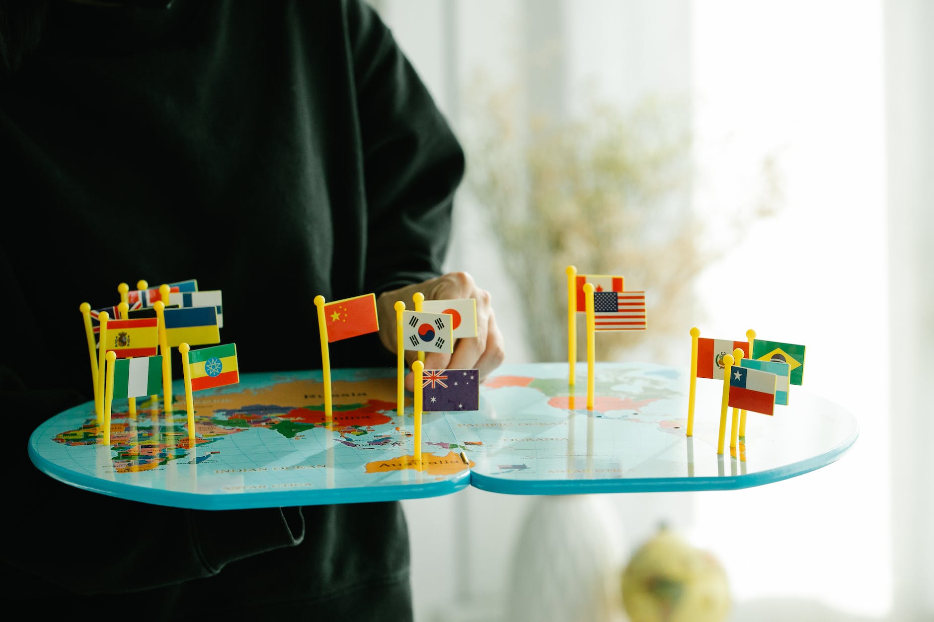 country flags pinned on a world map