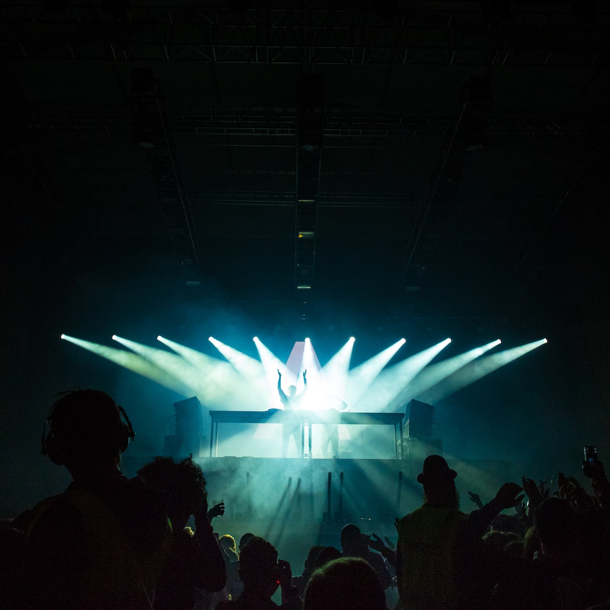 People Inside Dark Room With Spotlights