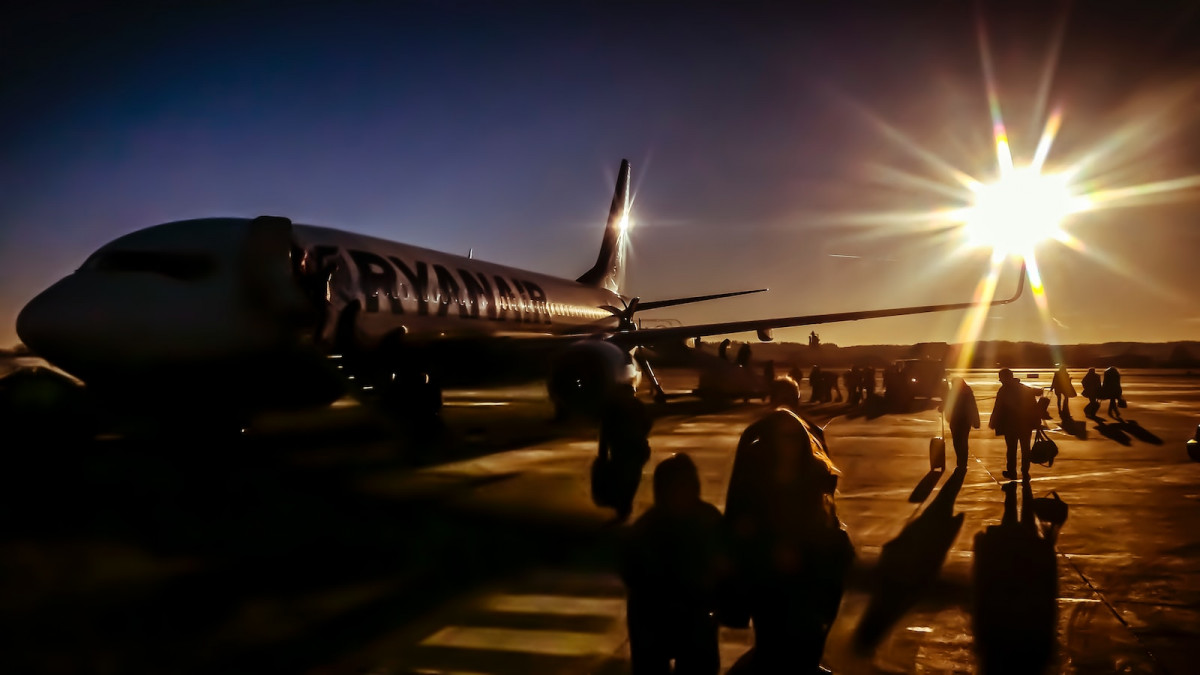 silhouette of people near plane