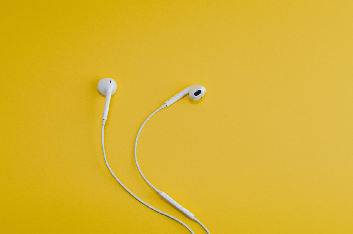 Apple EarPods on yellow surface