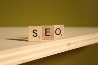 a wooden block that says SEO on it