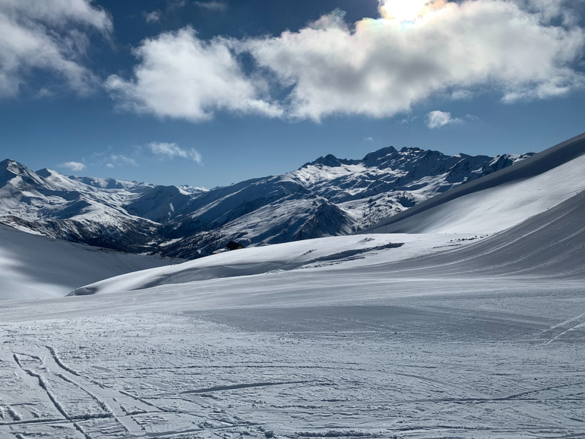 snow covered mountain under white clouds during daytime. Skiing API