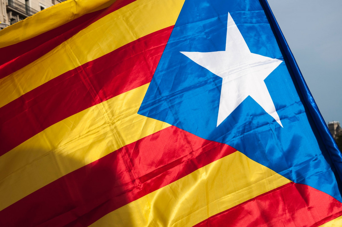 a close up of a flag with a building in the background