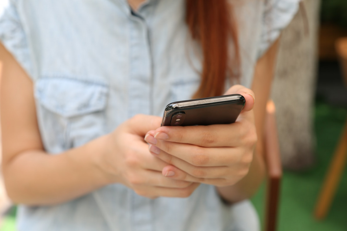 person holding using iPhone X