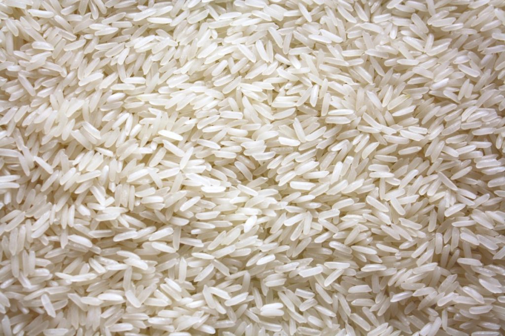 a pile of white rice sitting on top of a table - Rough Rice Prices API
